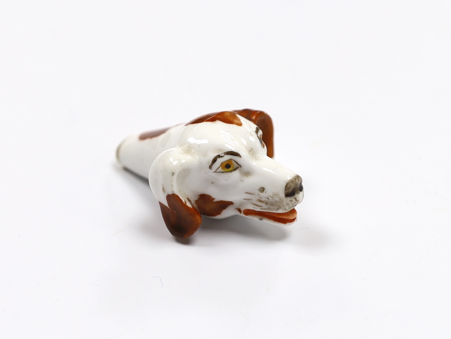 An early 19th century Staffordshire porcelain dog’s head whistle, 5cm